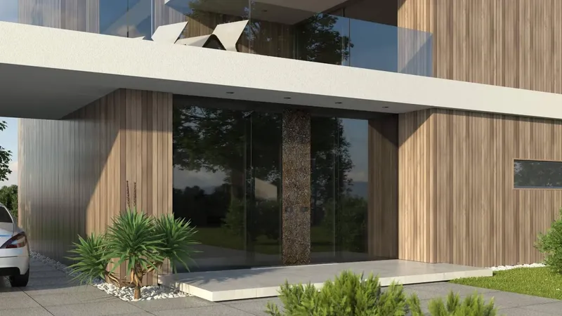 Steklena vrata z leseno obrobo in okrasnim stebrom na vhodu v stavbo.