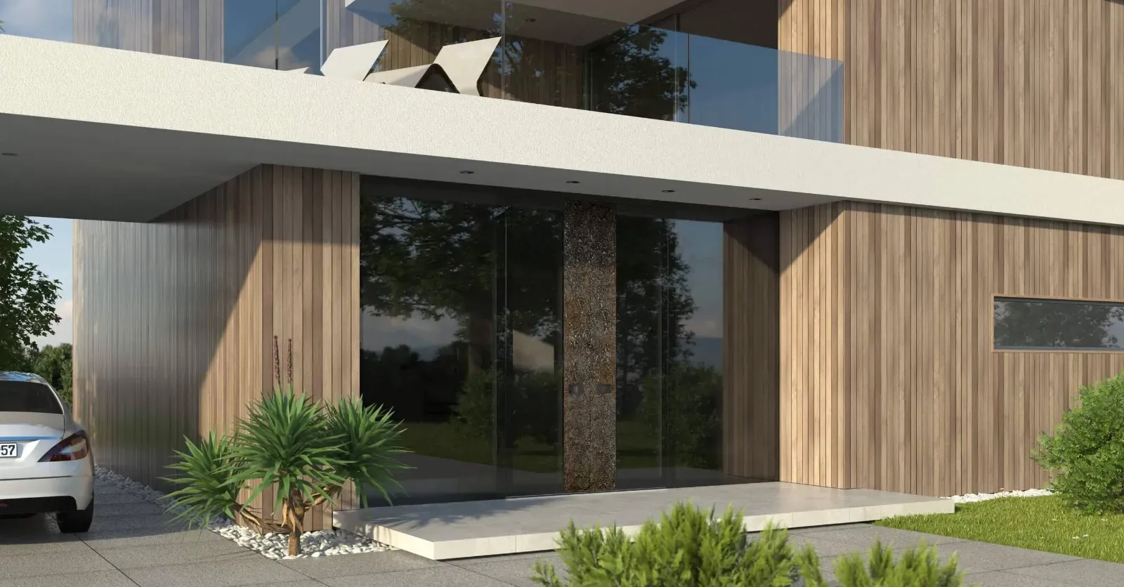 Steklena vrata z leseno obrobo in okrasnim stebrom na vhodu v stavbo.