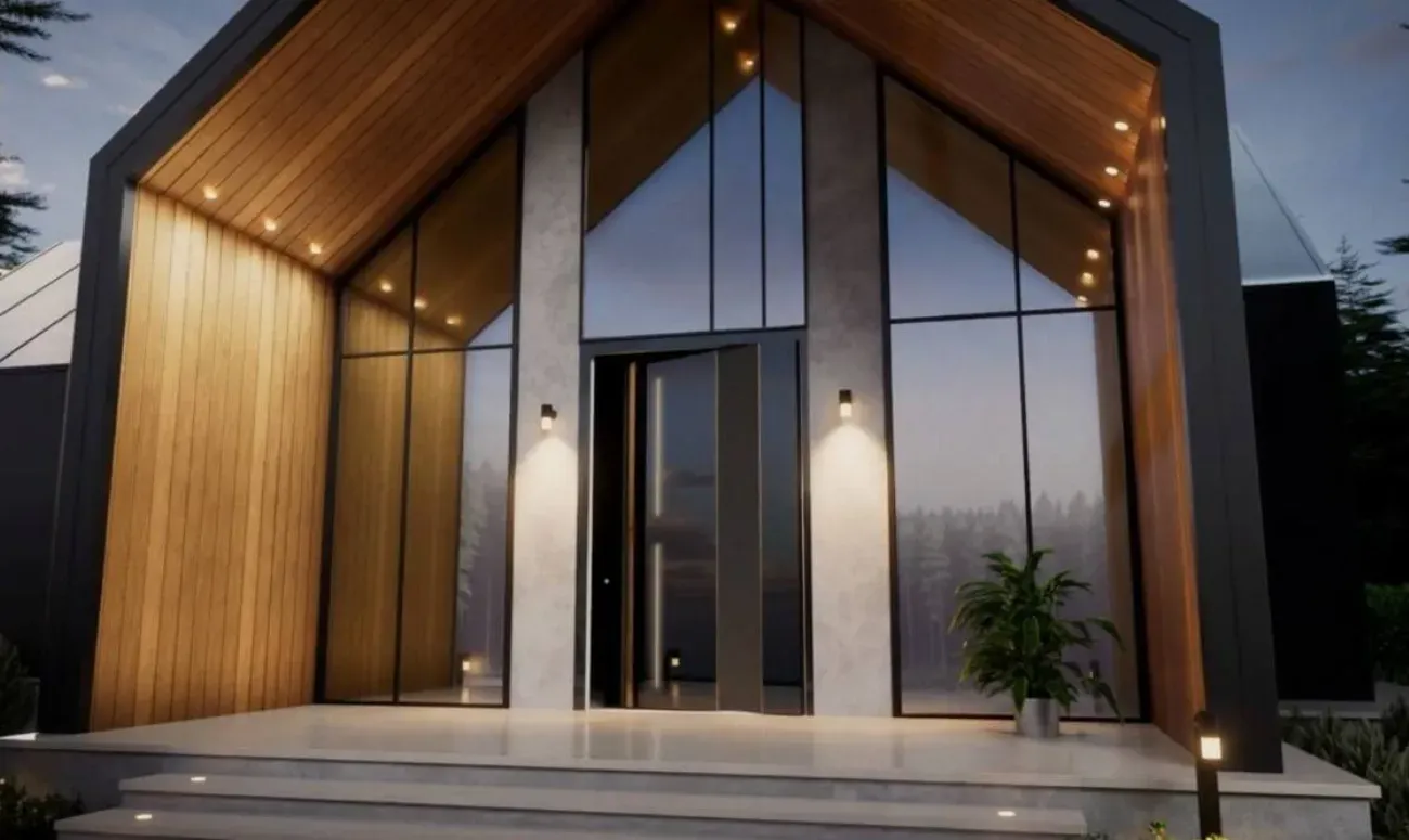 Vhodna vrata so široka in steklena, obkrožena z lesenimi paneli in svetili na obeh straneh.